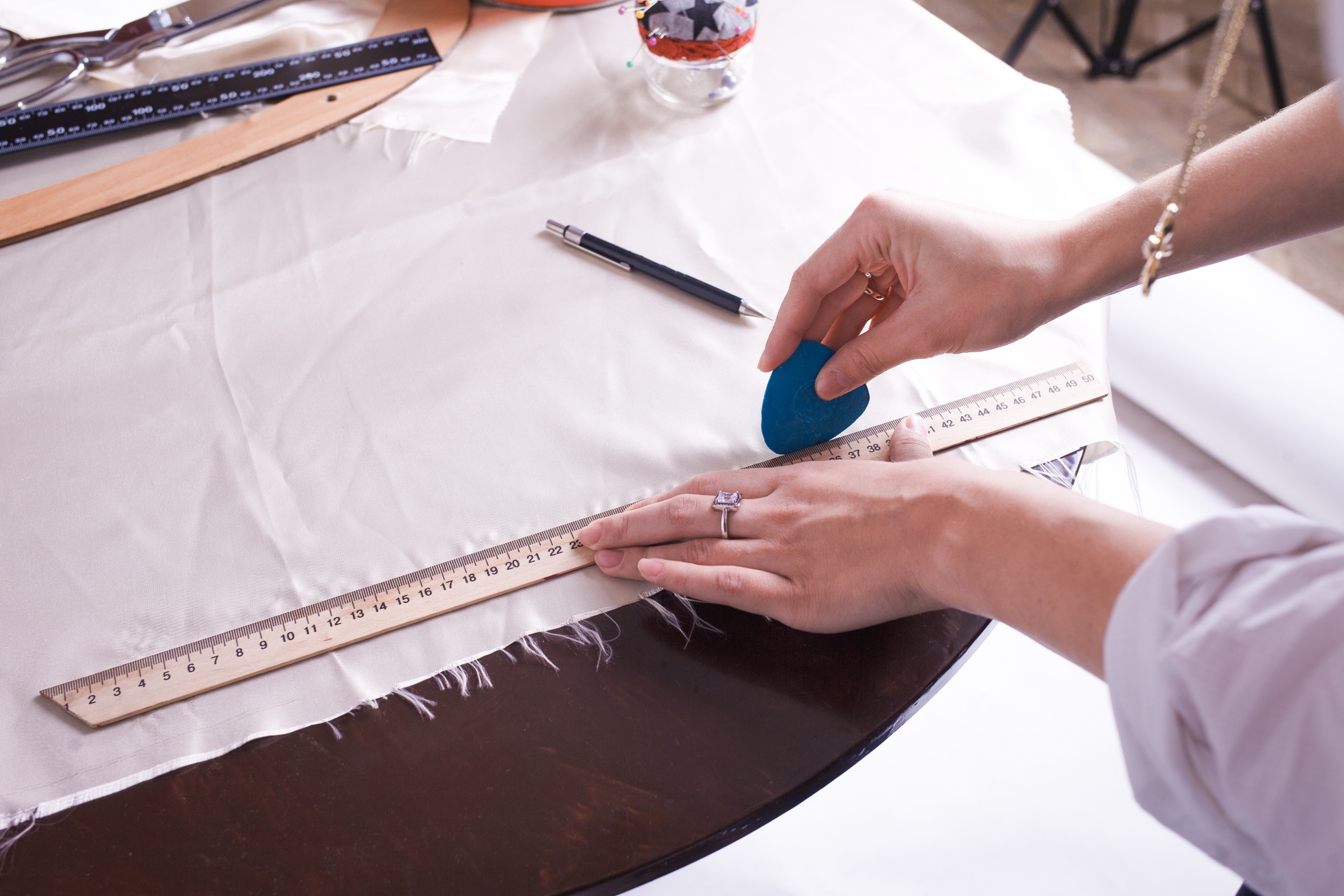 The seamstress makes a pattern for the future product. Sewing workshop